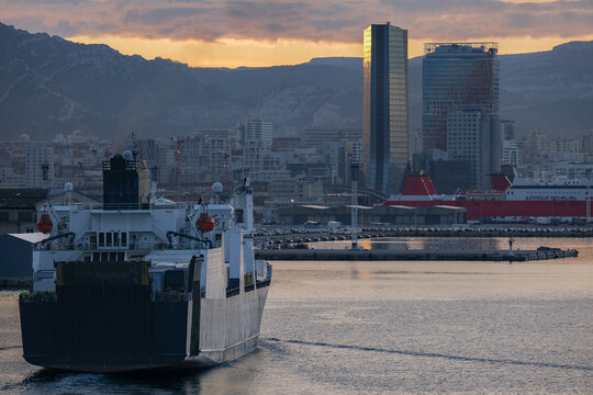 Large modern Passenger container freighter pax cargo roro ro-ro ferry Ark Futura liner arrival into port of Marseille, France during sunrise twilight