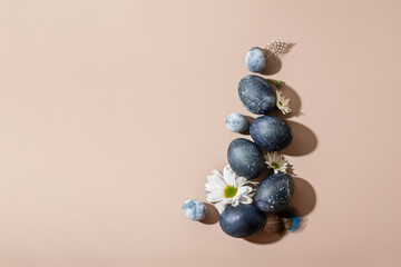 Easter eggs and flowers on a beige background. Happy easter