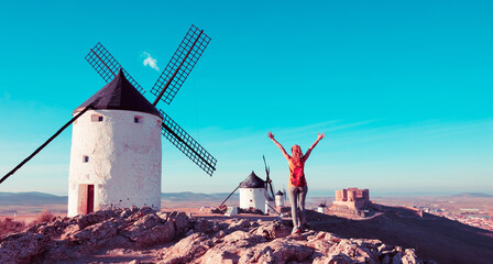 Molinos de consuegra - Consuegra Windmills and happy woman arms raised admiring panoramic view-...