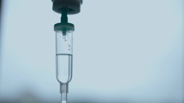 Close-up of the Infusion Process. Drop of Saline is Dripped for Intravenous Infusion IV During Chemotherapy.