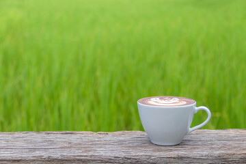 Coffee on old wood table and the plantation background with copy space for your text.