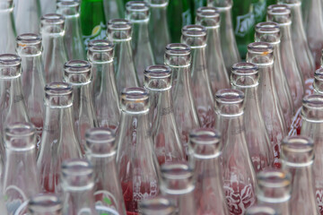 Empty glass bottles waiting for cleaning in factory to fill with drink.