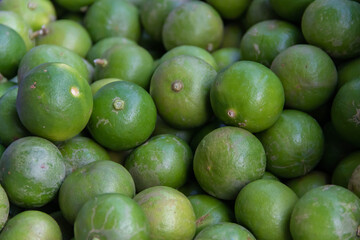 Stack of limes on display at street market with drink fresh lemonade.