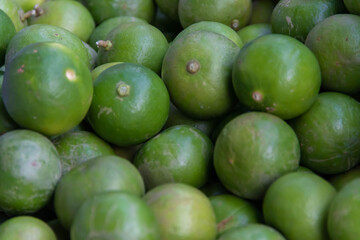 Stack of limes on display at street market with drink fresh lemonade.