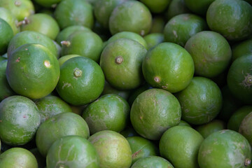 Stack of limes on display at street market with drink fresh lemonade.