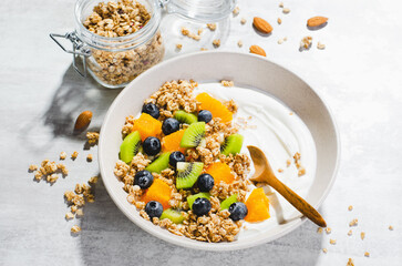 Yogurt with Granola, Kiwi, Blueberries, and Orange in a Bowl, Healthy Snack or Breakfast