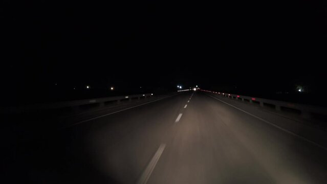 POV in the car, driving on a dark empty road, highway  in the middle of the night