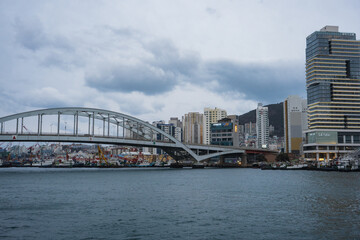 Busan Sea Port city view and Busan bridge during winter evening cloudy day at Jung-gu , Busan  South Korea : 9 February 2023