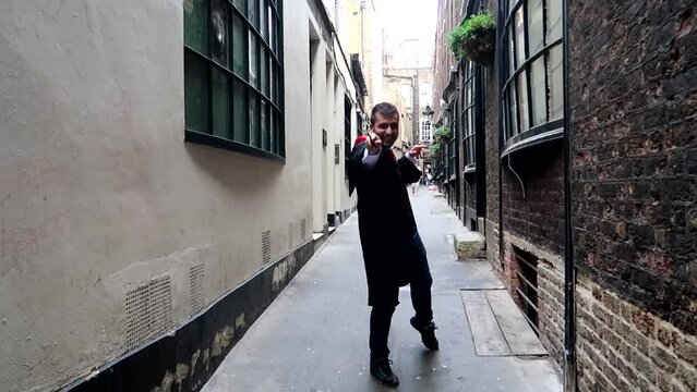 Man dressed up like Harry Potter using a wand in Goodwin's Court, London. Slowmo