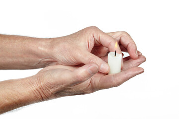 Men's hands holding a candle isolated white background. Man holding burning candle, closeup