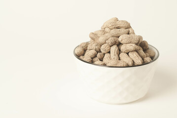 This high-quality image showcases perfectly roasted peanuts isolated on a clean white background, perfect for your food-related projects or blogs
