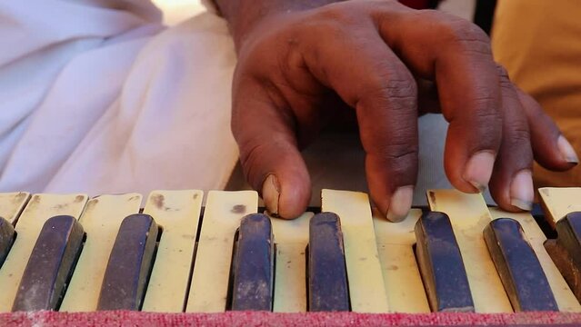 local artist plying reed organ colse up shot at day from different angle shot is taken at jaisalmer fort rajasthan india on Jan 25 2023.