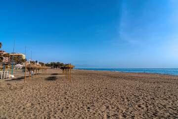 Carihuela playa between Torremolinos and Benalmadena with beach umbrellas Andalusia Costa del Sol Spain - obrazy, fototapety, plakaty