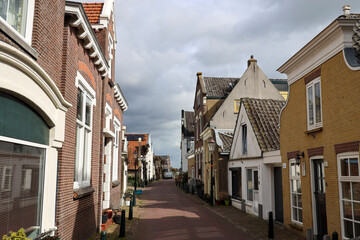 Old houses in the Dorpsstraat in village Moordrecht as part of the Dyke along river Hollandsche IJssel