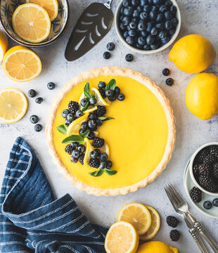Top view of lemon tart with blueberry and blackberry garnish.