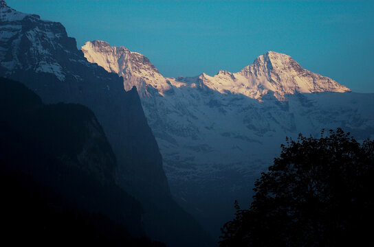 A view of the alpenglow on the high Alp mountains above Wengen