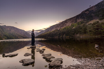 Closeup shot of a Caucasian male at Glendalough upper lake in Ireland