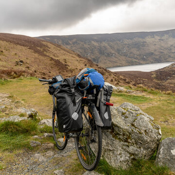 a Bike packer bike resting on mountainous landscape