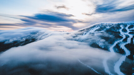 A blanket of clouds sit over Saddleback Ski area, Maine in winter