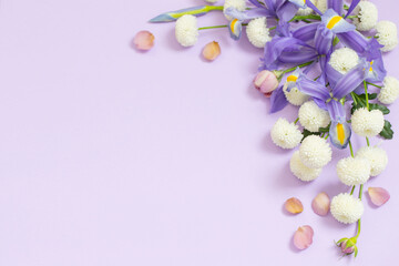 Fototapeta na wymiar beautiful flowers on purple paper background