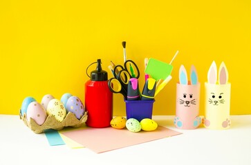 Spring Easter holiday.  Craft, children's creativity, on a colored background on the table are...