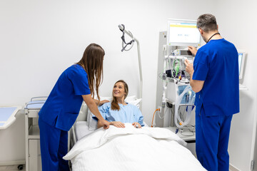 Hospital Ward: Friendly Doctor and nurse taking care of Beautiful Caucasian Female Patient Resting in Bed. Physician explains Test Results. Woman Recovering after Successful Surgery