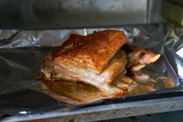 A piece of crispy lamb chops is being baked in the oven