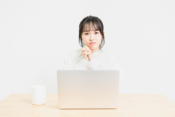PCを使いながらお願いしている若い女性