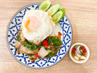 Rice topped with crispy pork belly with Thai basil and fried egg