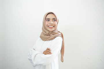 Smiling young Asian Muslim woman crossed arms and looking confident isolated over white background