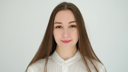 Fototapeta premium Portrait of young caucasian woman with long hair on white background. Healthy lifestyle concept