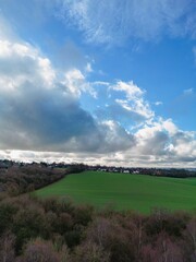 Fields and trees in UK village of Lingwood, idyllic rural landscape