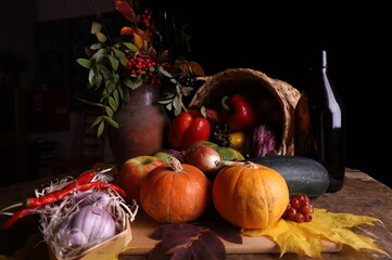 Autumn harvest including pumpkin, pepper, garlic, apples, berries, autumn leaves and berries