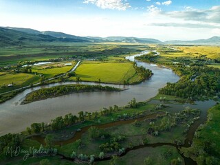 Breathtaking aerial view of Paradise Valley and Yellowstone River under a bright cloudy sky