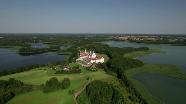 Drone view of Church and monastery at Wigry lake on a sunny day, Mazury, Podlaskie, Poland