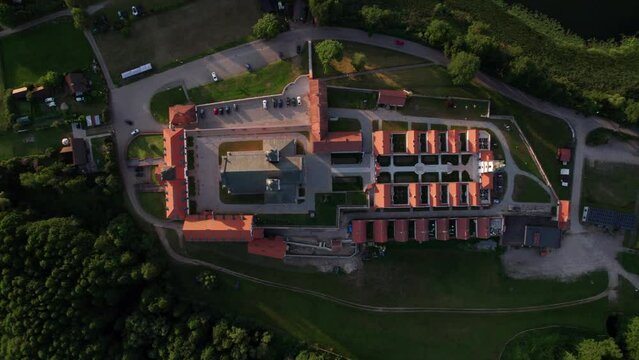 Top down Drone view of Church and monastery at Wigry lake during sunset, Mazury, Podlaskie, Poland