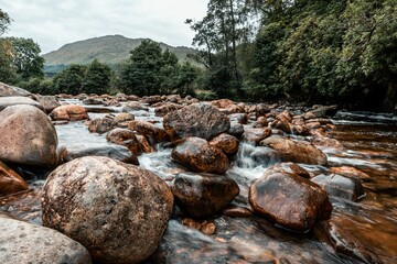 Beautiful shot of the rocky shore of Glenfinnan Viaduct in Scotland