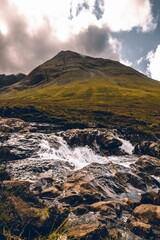Natural view of the Fairy Pools Waterfall near a forest in Scotland