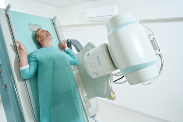 Adult man taking PA radiograph at the hospital radiology room