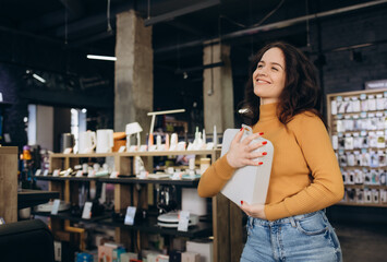 woman in an electronics store with a purchase