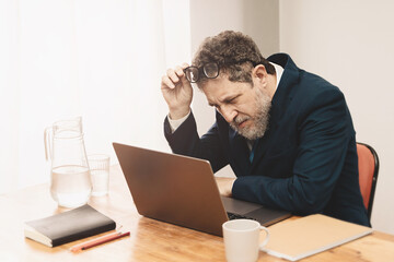 Middle-aged Man Struggling with Vision at Work