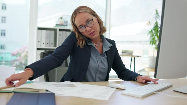 Asian woman, phone call and multitasking in busy business schedule on computer with paperwork at office desk. Fast female employee rushing work or tasks in productivity or efficiency at the workplace