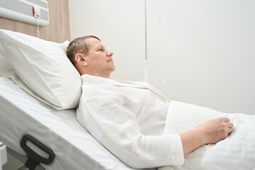 Adorable sad man patient in the white medical ward