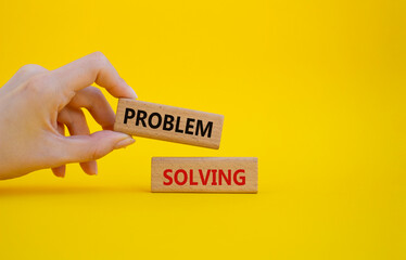 Problem solving symbol. Concept word Problem solving on wooden blocks. Businessman hand. Beautiful yellow background. Business and concept. Copy space