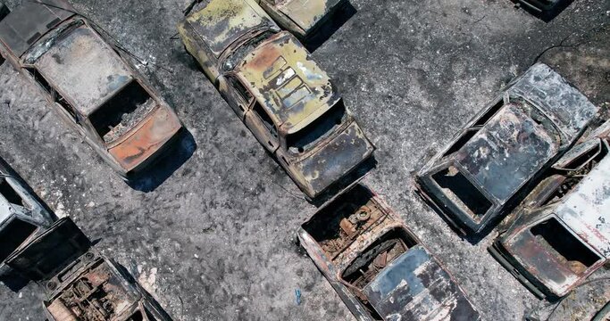 Aerial view of an aftermath of a big disaster of war, bushfire, volcano eruption, ash ground and burnt out cars
