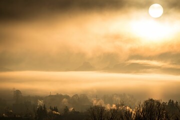 Town emitting smoke and polluting the air on the sunset