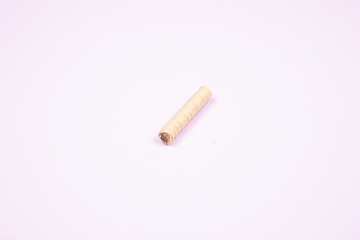 wafer roll with chocolate isolated on light purple background