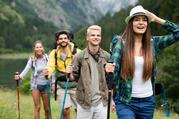 Group of fit healthy friends trekking in the mountains