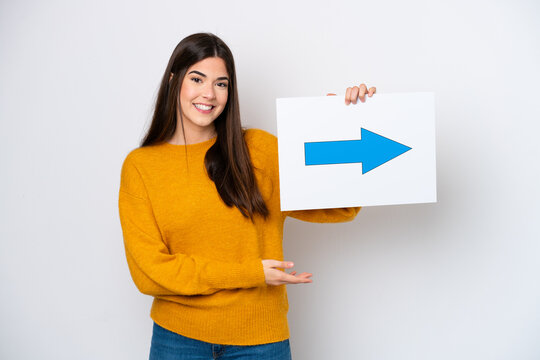 Young Brazilian woman isolated on white background holding a placard with arrow symbol with happy expression