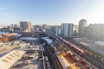 Obraz premium a red train traveling through the city during the day - time